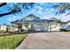 House exterior featuring a two-car garage and well-maintained lawn at 803 Innergary Pl, Valrico, FL 33594