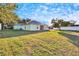 Back of house showing a screened patio and large grassy yard at 803 Innergary Pl, Valrico, FL 33594