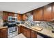 Modern kitchen with wood cabinets, granite countertops, and stainless steel appliances at 832 13Th N Ave, St Petersburg, FL 33701