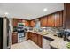 Modern kitchen with wood cabinets, granite counters, and stainless steel appliances at 832 13Th N Ave, St Petersburg, FL 33701