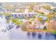 Aerial view of community featuring a pool, tennis courts, and lake access at 90 S Highland Ave # 7, Tarpon Springs, FL 34689