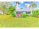 Landscaped backyard with lush greenery and a private deck at 90 S Highland Ave # 7, Tarpon Springs, FL 34689