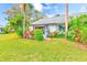 Landscaped backyard with lush greenery and a private deck at 90 S Highland Ave # 7, Tarpon Springs, FL 34689