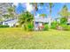 Landscaped backyard with lush greenery and a private deck at 90 S Highland Ave # 7, Tarpon Springs, FL 34689