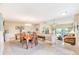 Open dining area with a wooden table and chairs, offering views of the living room at 90 S Highland Ave # 7, Tarpon Springs, FL 34689