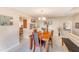 Bright dining room features a wooden table, chairs, and views into the kitchen at 90 S Highland Ave # 7, Tarpon Springs, FL 34689