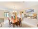 Comfortable dining area features a chandelier and seamlessly connects to the kitchen at 90 S Highland Ave # 7, Tarpon Springs, FL 34689