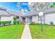 Attractive front entry with walkway and landscaping at 90 S Highland Ave # 7, Tarpon Springs, FL 34689