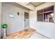 Charming front porch with brick accents, decorative welcome sign, and a stylish front door at 90 S Highland Ave # 7, Tarpon Springs, FL 34689