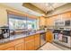 Well-lit kitchen with stainless steel appliances, granite countertops, and natural light at 90 S Highland Ave # 7, Tarpon Springs, FL 34689