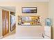 Kitchen view from dining area, with granite countertop bar, wood cabinets, and stainless steel appliances at 90 S Highland Ave # 7, Tarpon Springs, FL 34689