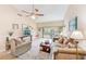 Comfortable living room featuring a ceiling fan and access to the patio through sliding glass doors at 90 S Highland Ave # 7, Tarpon Springs, FL 34689