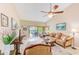 Bright living room with vaulted ceilings, comfy furniture, and access to a patio at 90 S Highland Ave # 7, Tarpon Springs, FL 34689