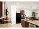 Modern kitchen with granite countertops and dark cabinets at 10029 Warm Stone St, Thonotosassa, FL 33592