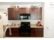 Modern kitchen with granite countertops and dark wood cabinets at 10029 Warm Stone St, Thonotosassa, FL 33592