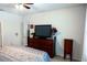 Main bedroom with dresser, TV, and ensuite access at 10029 Warm Stone St, Thonotosassa, FL 33592