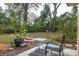 Landscaped backyard with chair and table, ample green space at 1018 E Hanna Ave, Tampa, FL 33604