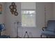 Bedroom with wood flooring, window, and music stand at 1018 E Hanna Ave, Tampa, FL 33604