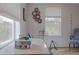 Bedroom with wood flooring, guitar, and comfortable armchair at 1018 E Hanna Ave, Tampa, FL 33604