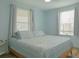 Light blue bedroom with a king-size bed and wood floors at 1018 E Hanna Ave, Tampa, FL 33604