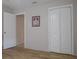 Simple bedroom with light walls, wood-look flooring, and a double door closet at 1018 E Hanna Ave, Tampa, FL 33604