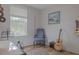 Bedroom with wood flooring, guitar, and comfortable armchair at 1018 E Hanna Ave, Tampa, FL 33604