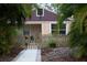 Cute bungalow with a fenced yard and walkway at 1018 E Hanna Ave, Tampa, FL 33604