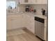 Kitchen corner with white cabinets, quartz countertops, and stainless steel dishwasher at 1018 E Hanna Ave, Tampa, FL 33604