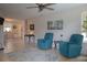 Bright living room with comfy armchairs and a ceiling fan at 1018 E Hanna Ave, Tampa, FL 33604