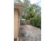 Sandy side yard with wooden fence and gate at 1018 E Hanna Ave, Tampa, FL 33604