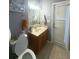 Well-lit bathroom with a single vanity and toilet at 10537 Sky Flower Ct, Land O Lakes, FL 34638