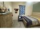 Bedroom with striped bed and blue chair at 10537 Sky Flower Ct, Land O Lakes, FL 34638