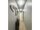 Bright hallway with tile floors, recessed lighting, and decorative wall art at 10537 Sky Flower Ct, Land O Lakes, FL 34638