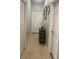 Clean hallway with tile floors and decorative accents at 10537 Sky Flower Ct, Land O Lakes, FL 34638