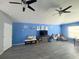 Spacious living room with blue walls, vinyl plank floors, and ceiling fans at 10537 Sky Flower Ct, Land O Lakes, FL 34638