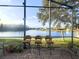 Lake view from a screened patio with wicker furniture at 10537 Sky Flower Ct, Land O Lakes, FL 34638