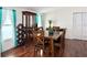 Dining room with wooden table and chairs, hutch, and teal curtains at 10538 Bay Hills Cir, Thonotosassa, FL 33592