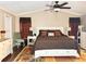 Bright main bedroom with king-size bed and ceiling fan at 10538 Bay Hills Cir, Thonotosassa, FL 33592