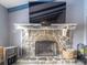 Stone fireplace with black metal screen in a living room with hardwood floors at 1080 Buena Vista Ave, Brooksville, FL 34601