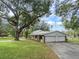 Home with attached two-car garage and expansive lawn at 1080 Buena Vista Ave, Brooksville, FL 34601