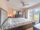 Main bedroom with a king-size bed, French doors, and access to the backyard at 1080 Buena Vista Ave, Brooksville, FL 34601