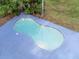 Kidney shaped pool with surrounding patio at 1080 Buena Vista Ave, Brooksville, FL 34601