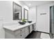 Modern bathroom with double sinks, quartz countertop, and a large shower at 1120 E Kennedy Blvd # 413, Tampa, FL 33602