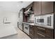 Modern kitchen with stainless steel appliances and dark cabinetry at 1120 E Kennedy Blvd # 413, Tampa, FL 33602