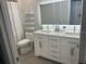 Updated bathroom with double vanity and LED mirror lighting at 11719 Mango Groves Blvd, Seffner, FL 33584