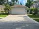 Attached garage with driveway, offering ample parking space at 11719 Mango Groves Blvd, Seffner, FL 33584