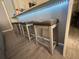 Kitchen island with four barstools and LED underlighting at 11719 Mango Groves Blvd, Seffner, FL 33584