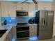 Modern kitchen with stainless steel appliances and LED lighting at 11719 Mango Groves Blvd, Seffner, FL 33584