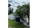 Side yard with a trash can and a palm tree at 11719 Mango Groves Blvd, Seffner, FL 33584