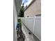 Side yard with a paved walkway and white fence at 11719 Mango Groves Blvd, Seffner, FL 33584